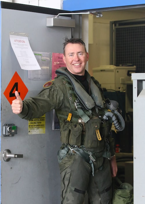 Matt Stoll in his flight suit giving the thumbs up